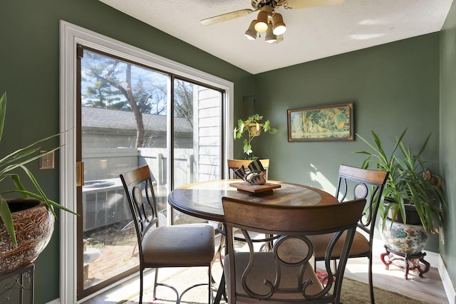 dining space with a ceiling fan