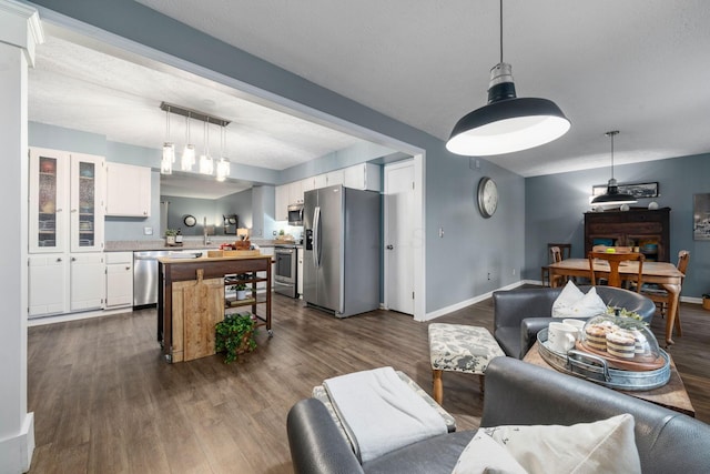 living area with visible vents, baseboards, and dark wood-style flooring