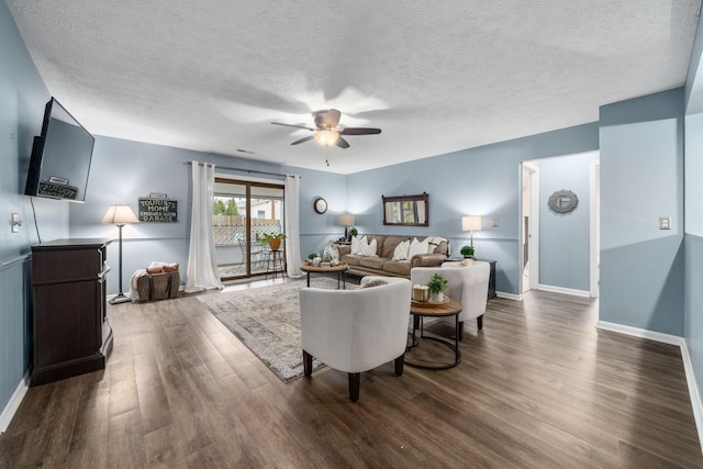 living area featuring ceiling fan, a textured ceiling, wood finished floors, and baseboards