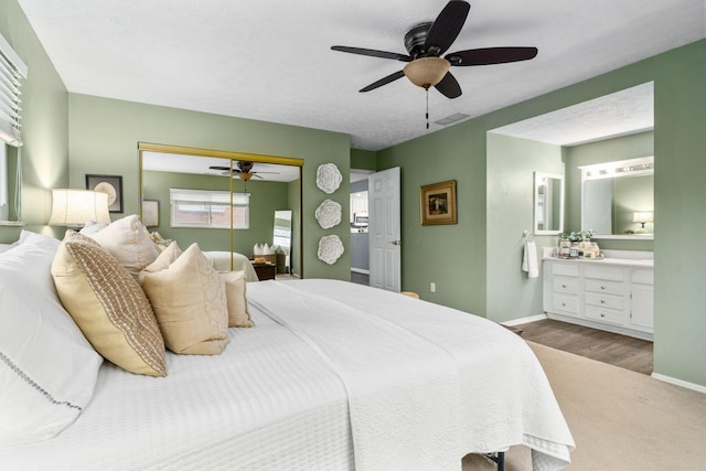 bedroom with a ceiling fan, baseboards, visible vents, and a closet