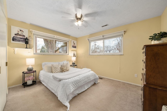 bedroom with multiple windows, carpet flooring, and visible vents