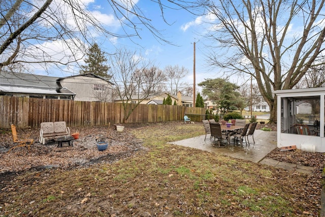 view of yard with a sunroom, a patio area, and a fenced backyard