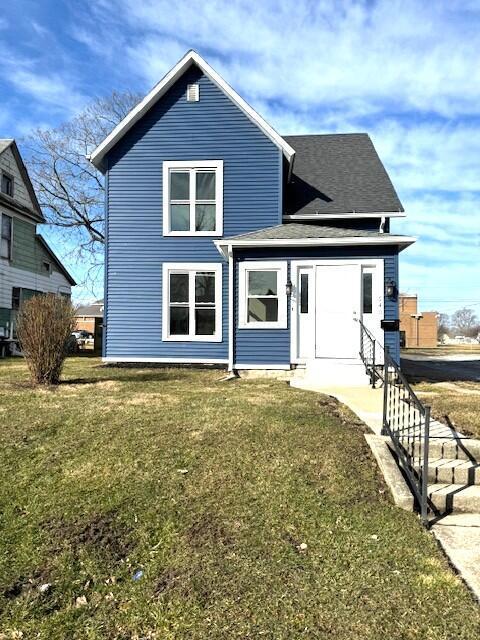 view of front of house with a front yard and roof with shingles