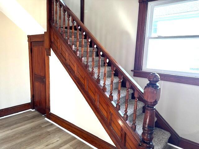 stairs featuring baseboards and wood finished floors