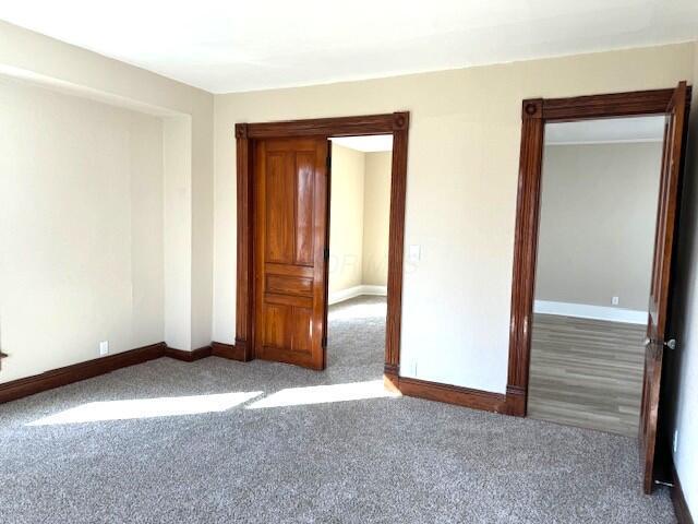 empty room with carpet and baseboards