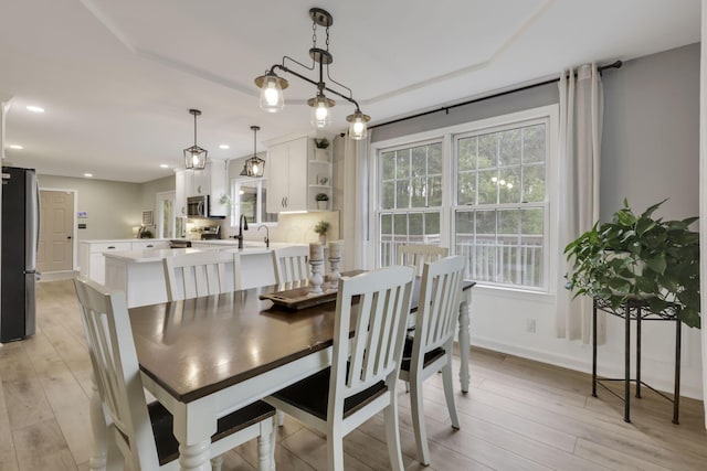 dining room featuring baseboards, recessed lighting, and light wood-style floors