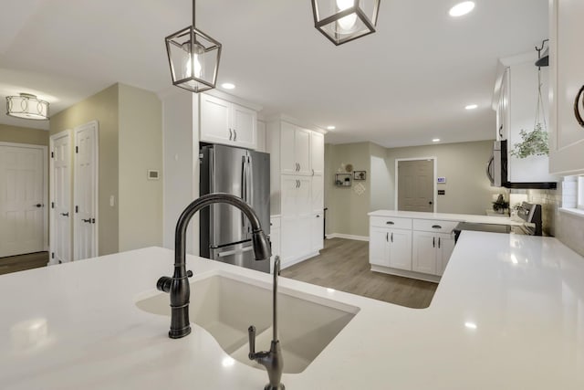 kitchen with recessed lighting, light countertops, white cabinetry, and appliances with stainless steel finishes