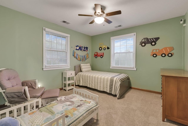 bedroom featuring carpet flooring, baseboards, visible vents, and ceiling fan