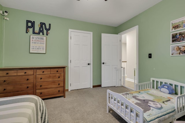 bedroom with carpet floors and baseboards