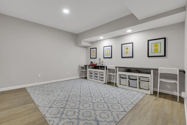 interior space featuring recessed lighting, baseboards, and wood finished floors