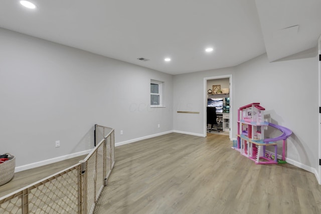 recreation room with recessed lighting, baseboards, wood finished floors, and visible vents