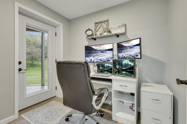 office with light wood-style flooring