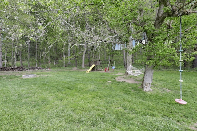view of yard with a playground and an outdoor fire pit