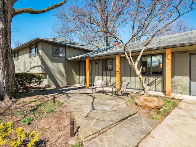 view of front of house with a chimney and a patio