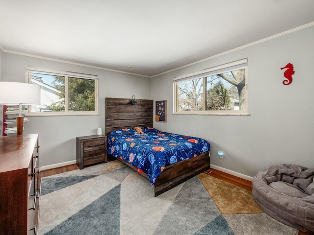 bedroom with multiple windows, baseboards, and ornamental molding