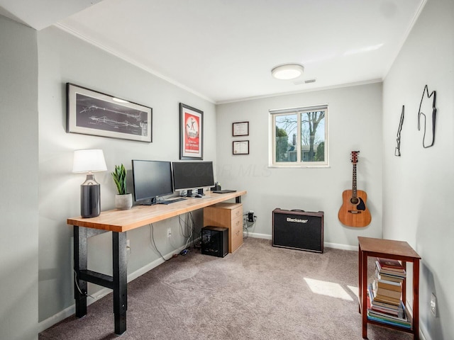 office space featuring visible vents, baseboards, carpet flooring, and crown molding