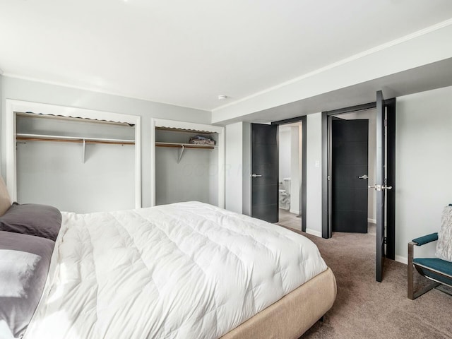 bedroom with baseboards, two closets, and carpet