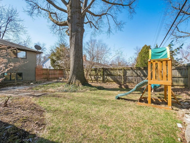 view of yard featuring a fenced backyard and a playground