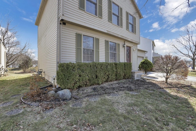 view of side of property with a lawn