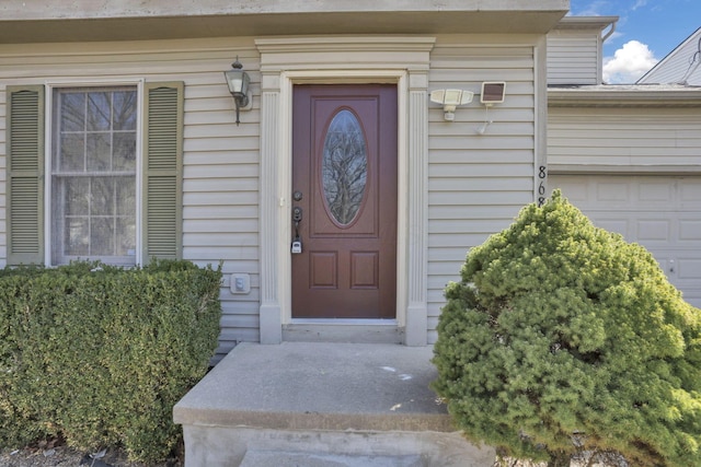 doorway to property with a garage