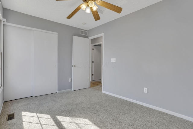 unfurnished bedroom featuring visible vents, baseboards, and carpet