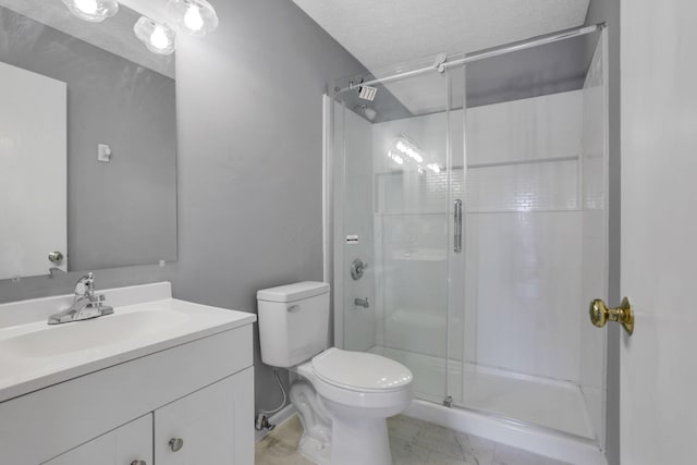 bathroom featuring vanity, a stall shower, a textured ceiling, toilet, and marble finish floor