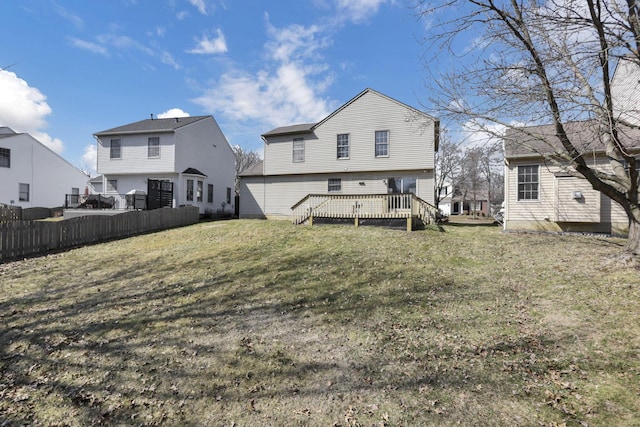 back of house featuring a deck, a yard, and fence