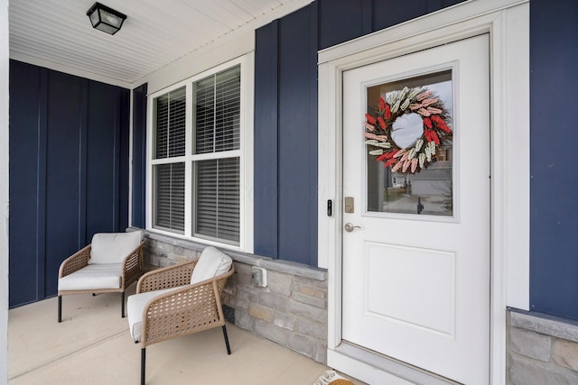 property entrance with a porch and board and batten siding