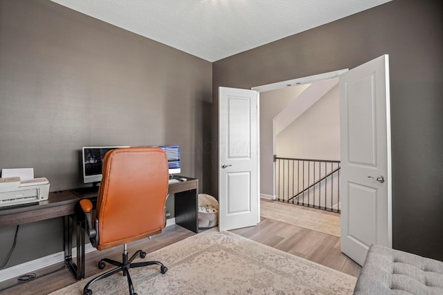 home office with wood finished floors and baseboards