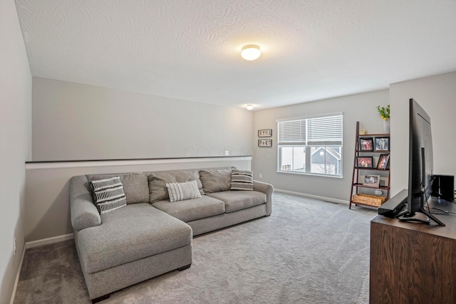 carpeted living room featuring a textured ceiling and baseboards