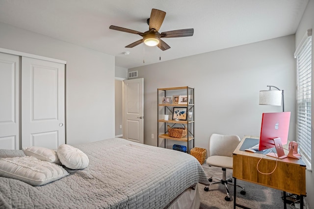 bedroom with carpet flooring, a ceiling fan, visible vents, and a closet