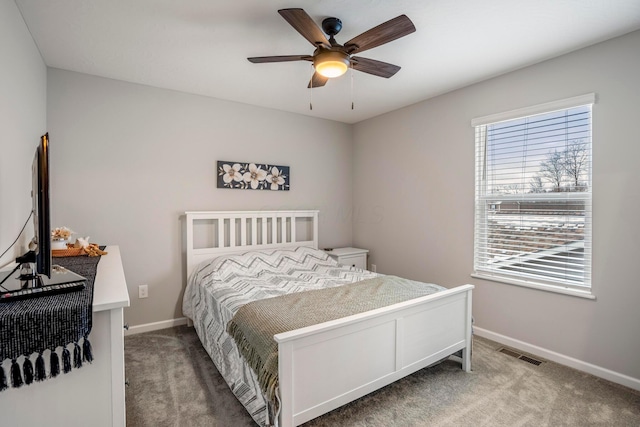 carpeted bedroom with a ceiling fan, baseboards, and visible vents