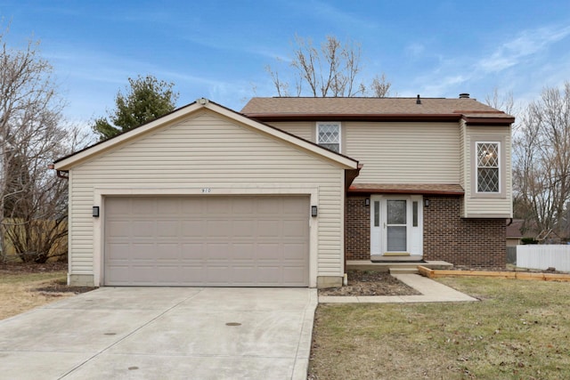 traditional-style home with brick siding, concrete driveway, fence, a garage, and a front lawn