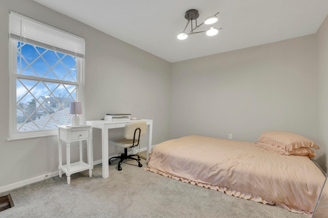 bedroom with carpet flooring and baseboards