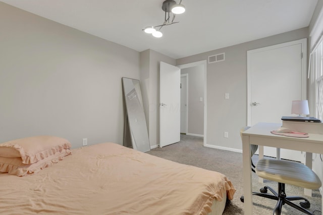 carpeted bedroom with visible vents and baseboards