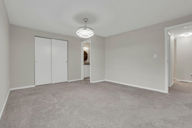 unfurnished bedroom featuring a closet, baseboards, and carpet flooring