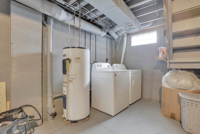 clothes washing area featuring laundry area, water heater, and independent washer and dryer