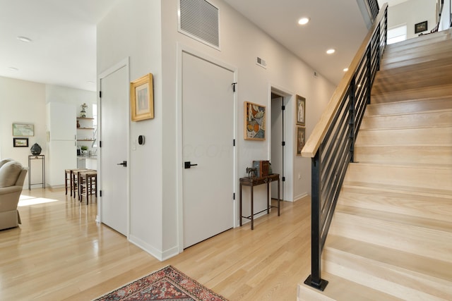 interior space featuring light wood-style flooring, stairway, visible vents, and recessed lighting