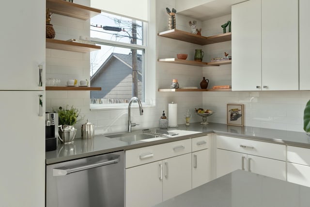 kitchen featuring a sink, plenty of natural light, open shelves, and stainless steel dishwasher