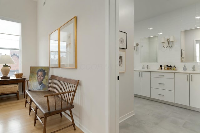 bathroom featuring double vanity and baseboards