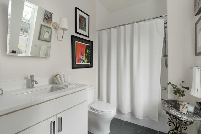 bathroom featuring tile patterned flooring, shower / tub combo with curtain, vanity, and toilet