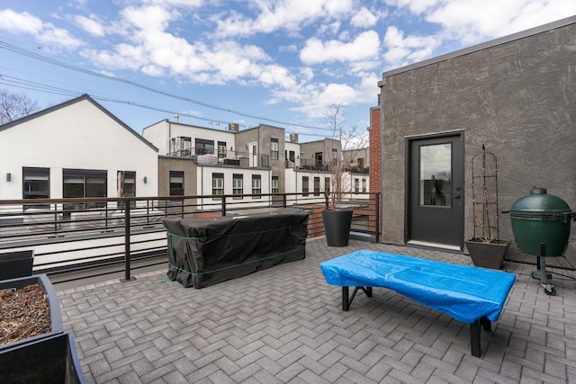 view of patio / terrace with grilling area and a balcony