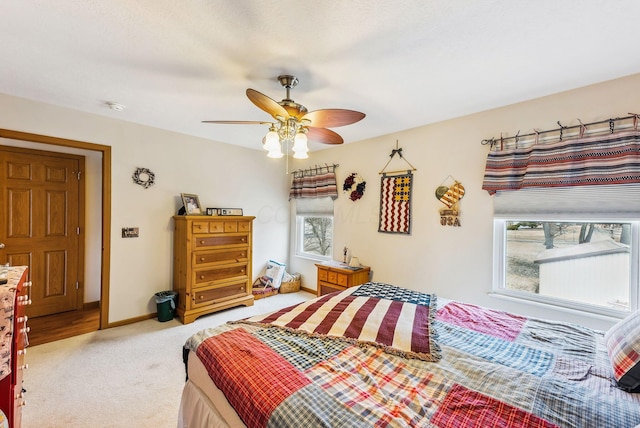 bedroom featuring ceiling fan, carpet floors, and baseboards