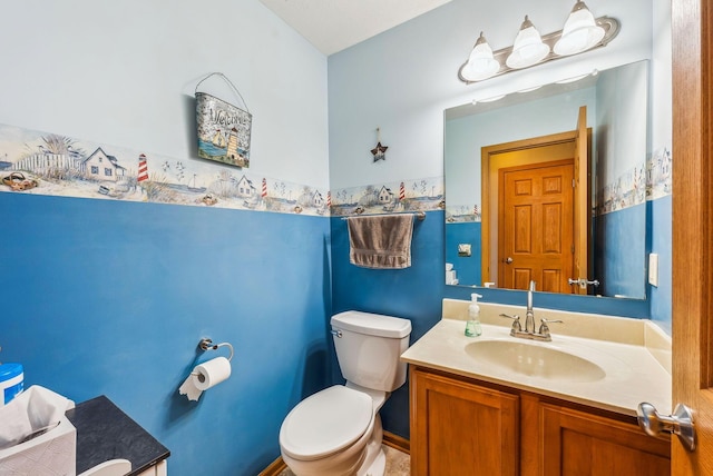 bathroom featuring toilet and vanity