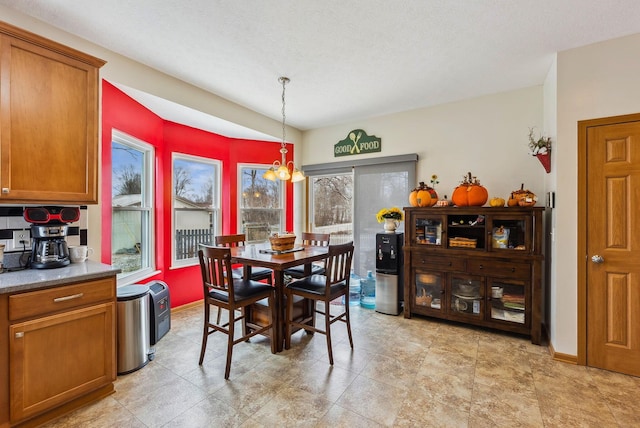 dining room with a notable chandelier and baseboards