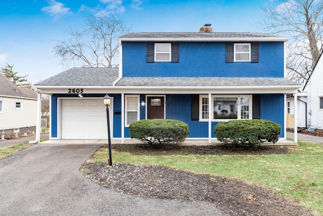 traditional-style home with a shingled roof, a chimney, an attached garage, and aphalt driveway