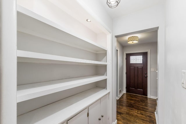 entrance foyer with dark wood finished floors and baseboards