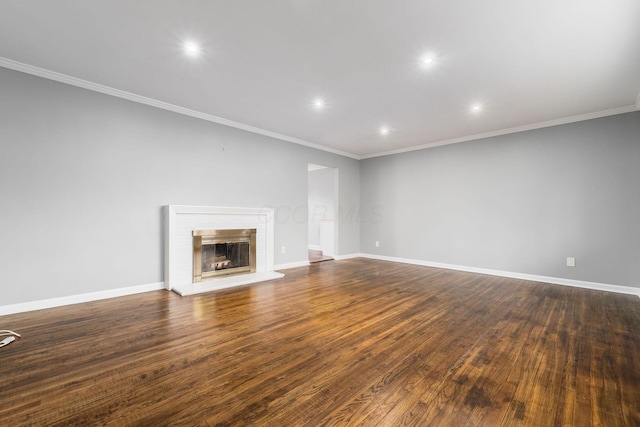 unfurnished living room featuring crown molding, dark wood-type flooring, a fireplace, and baseboards