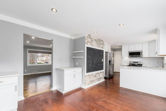 kitchen with stainless steel appliances, white cabinetry, dark wood-style floors, and open shelves