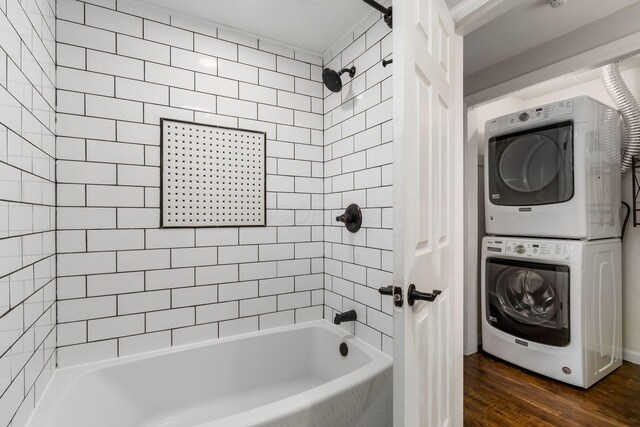 full bathroom featuring shower / bathing tub combination, wood finished floors, and stacked washer and clothes dryer